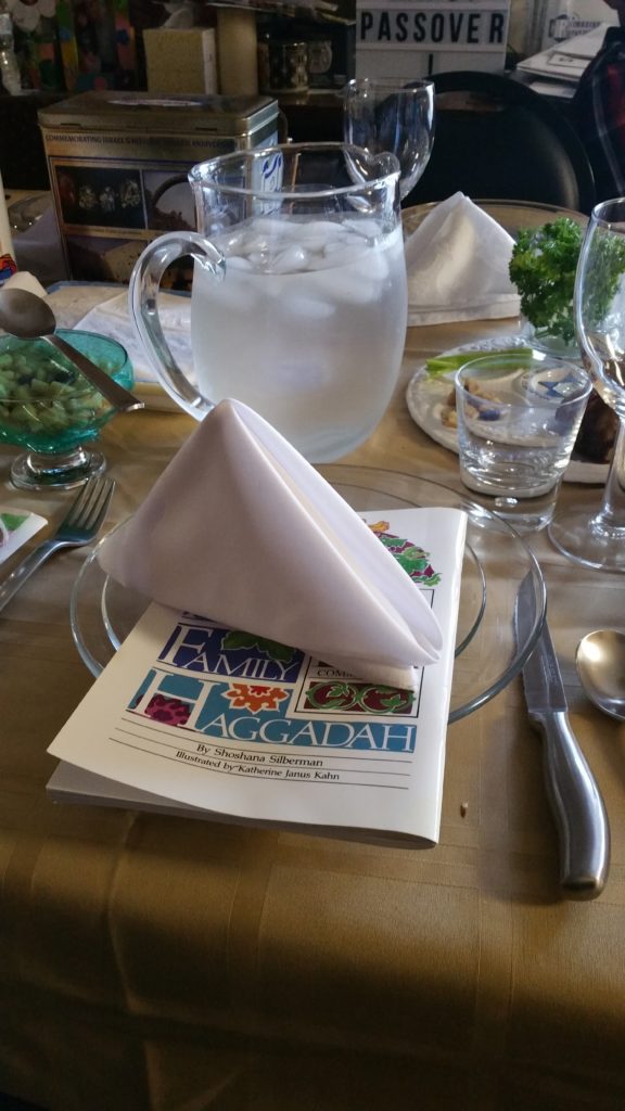 The napkin with the nice pyramid fold ready to be used during the seder.