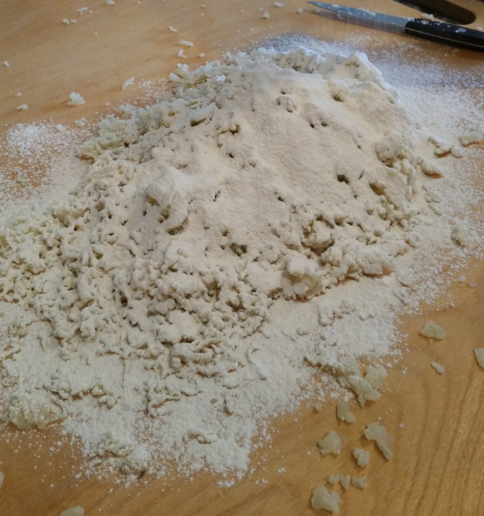 Sifted flour has been added to the potato and egg.