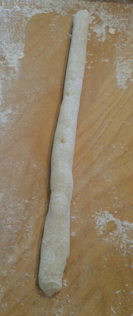 This fun part is reminiscent of preschool. Take of a piece of the dough and roll it into a "snake."