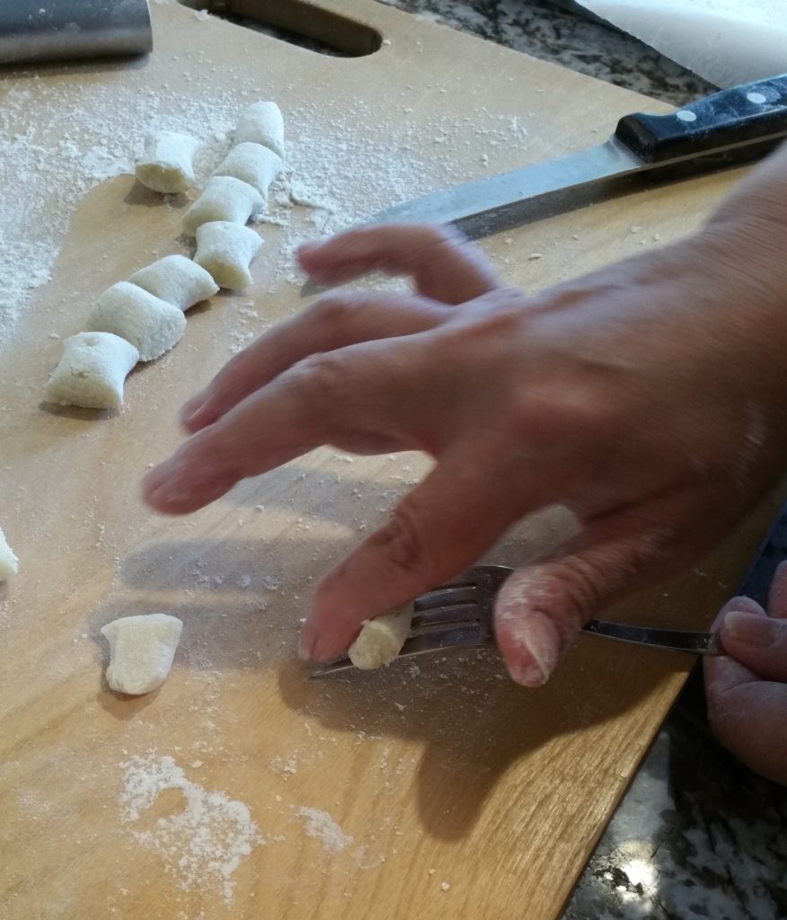 After the "snake" of dough was cut into smaller pieces, Diane showed me how to use a fork to make ridges on the gnocchi.