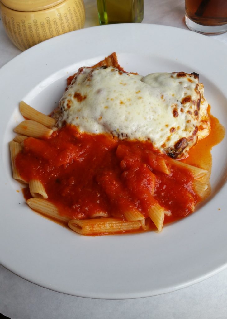 Eggplant parmigiana with a side of pasta with marinara sauce.