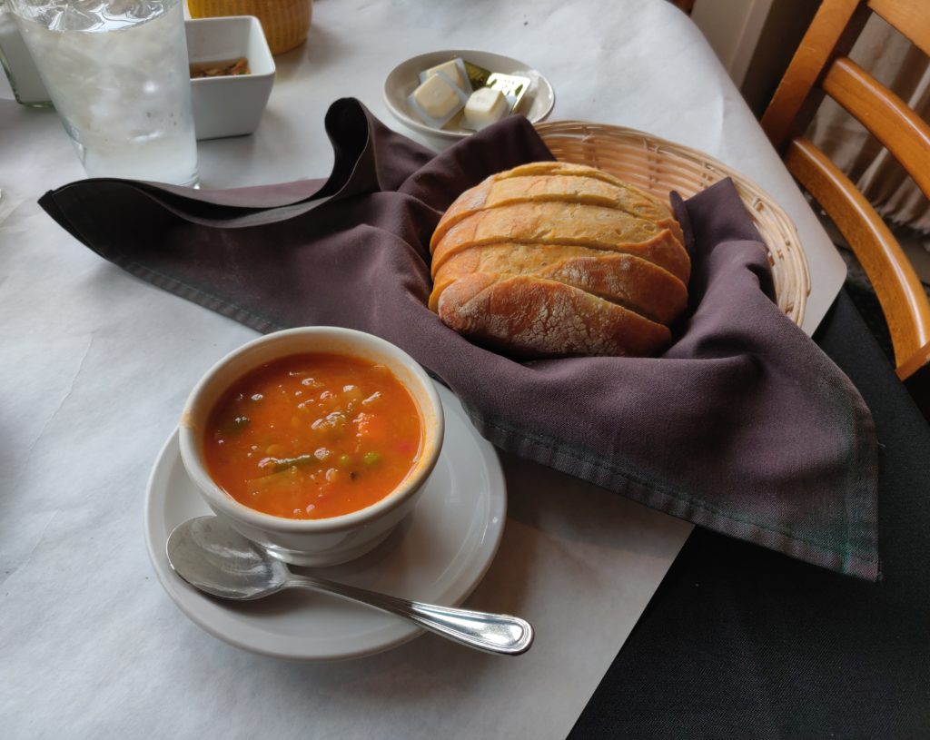 A cup of minestrone soup and a basket of bread. Neither stayed full for long.