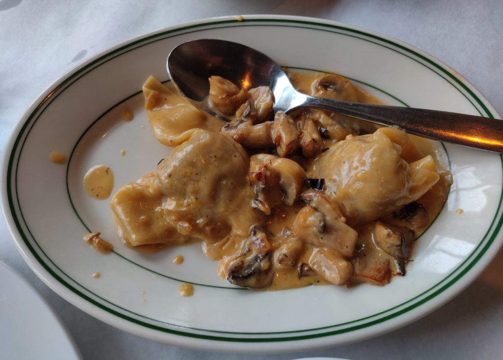Cappellacci stuffed with short ribs and served with a creamy Marsala sauce with mushrooms on top