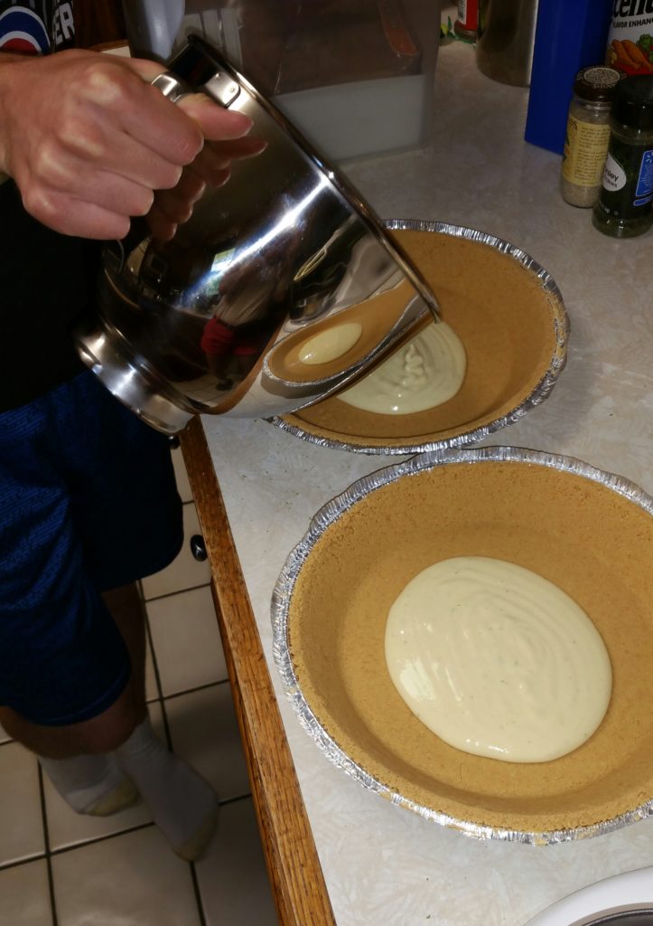 Pouring the filling into the crusts. Another thing I learned from this project was that I should be more aware of reflections. You can now see more than just my slippers in the bowl!