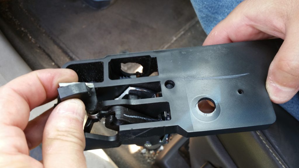 The broken part of the old door handle assembly