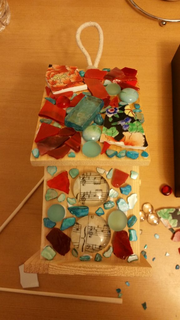 Making progress. The musical notes are on a piece of vellum which was glued to the underside of the glass bead.