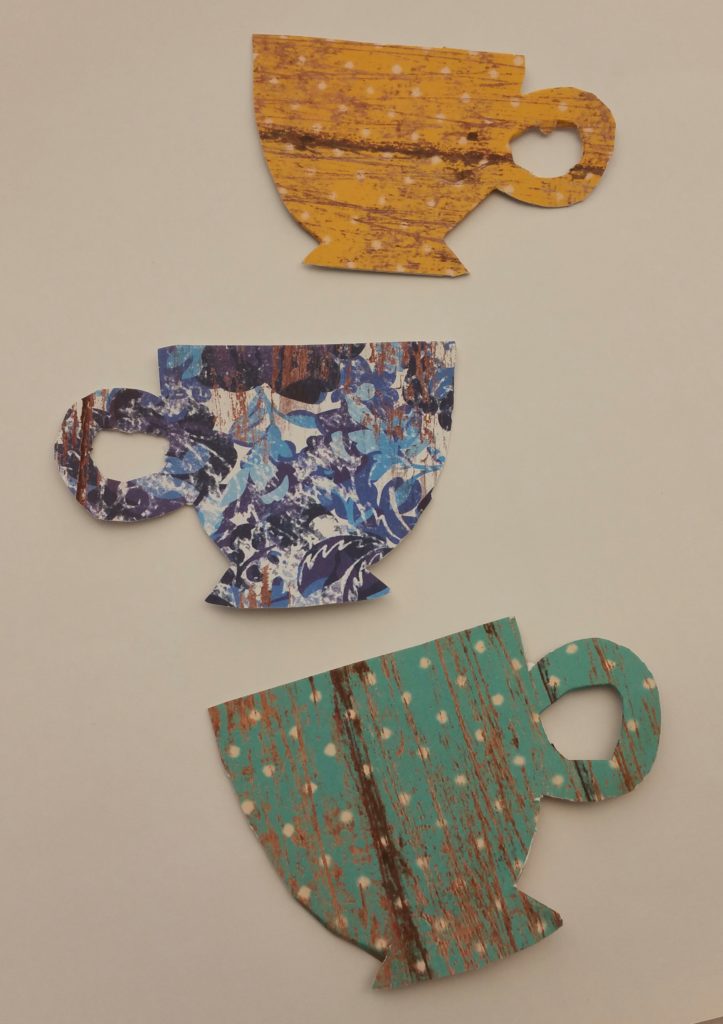 Once glued onto the decorative paper, the shapes were cut out. They didn't have to be cut perfectly. Some of the excess paper was folder over the edges.