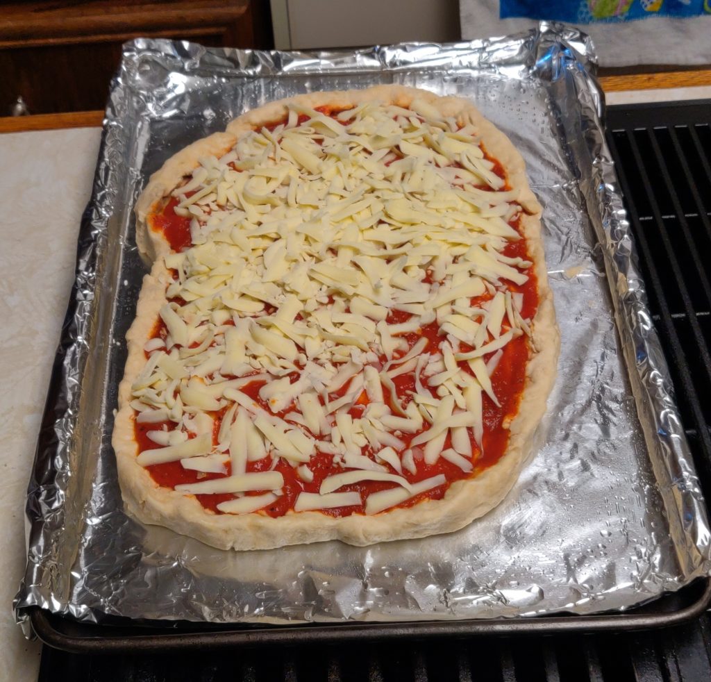 The pizza is ready for the oven.